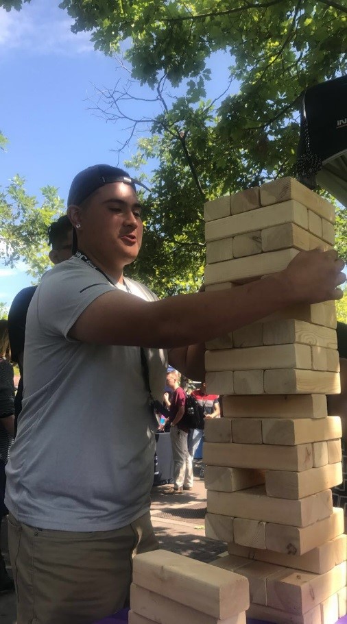 Student playing giant Jenga welcome back students