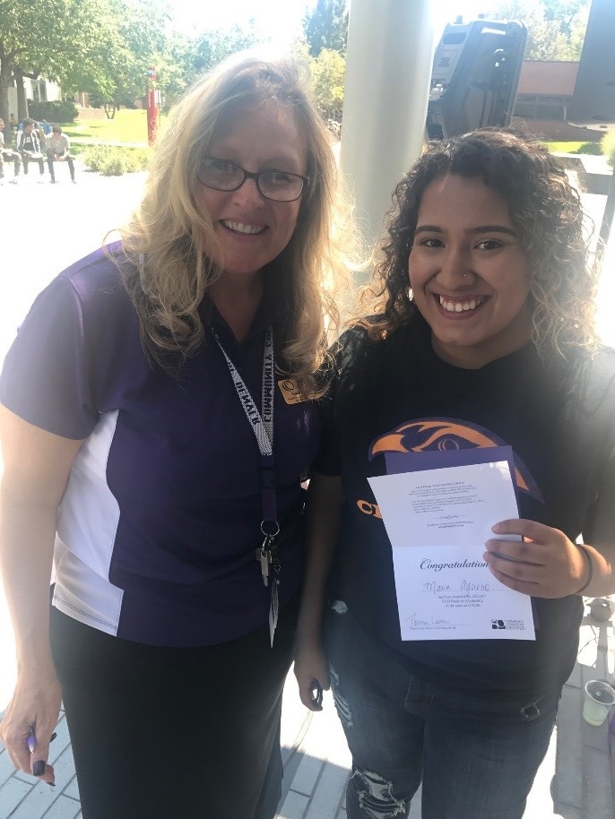 Enrollment Services Dean Tami Selby with a student two females, one holding a certificate